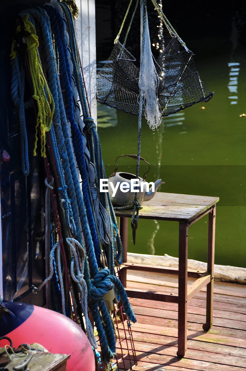 Fishing net on wooden post in lake