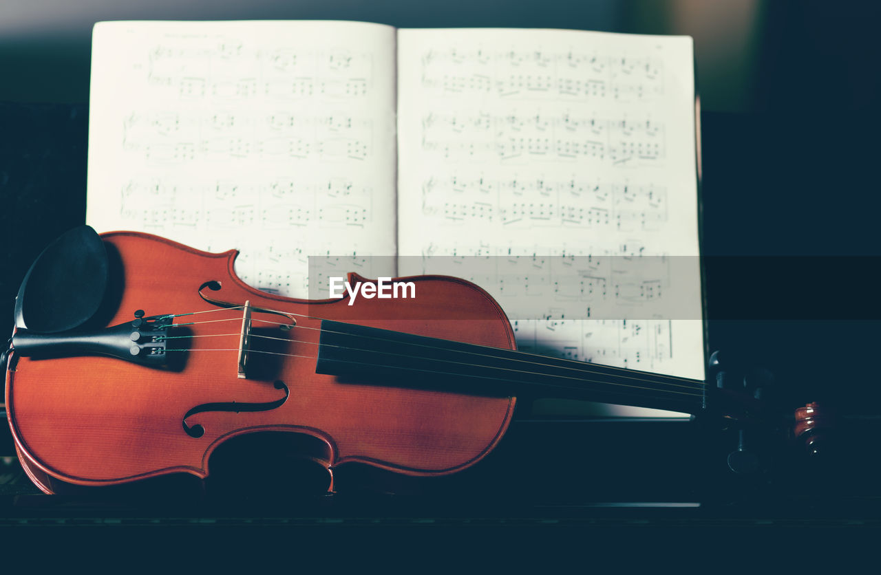 Close-up of violin on sheet music