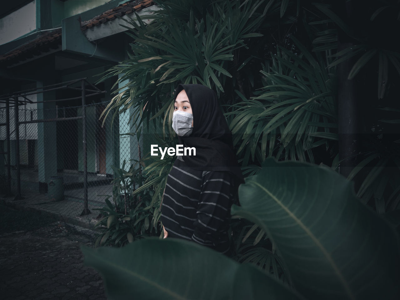 Portrait of man standing against plants