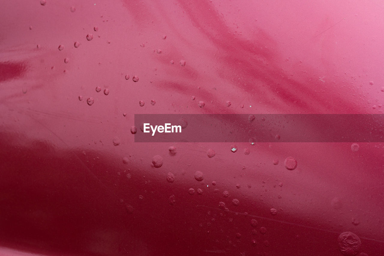 Full frame shot of raindrops on pink