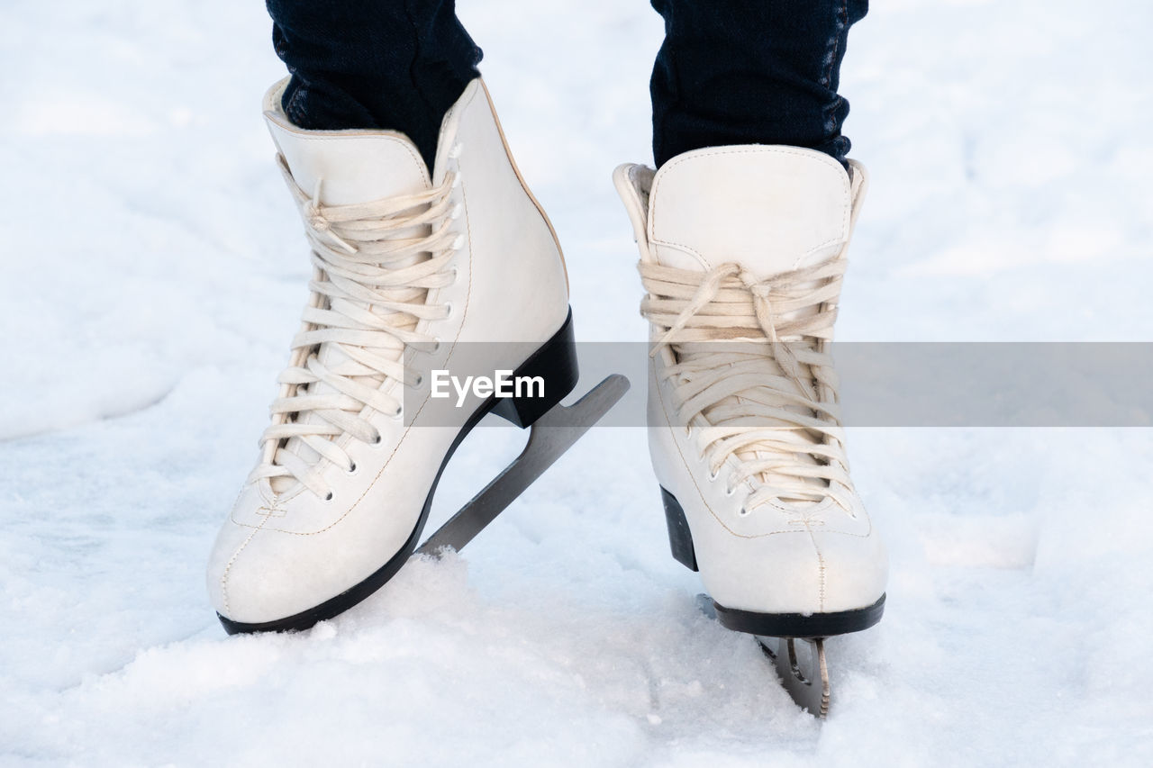 Woman skating at ice. close up of feet with ice skates on