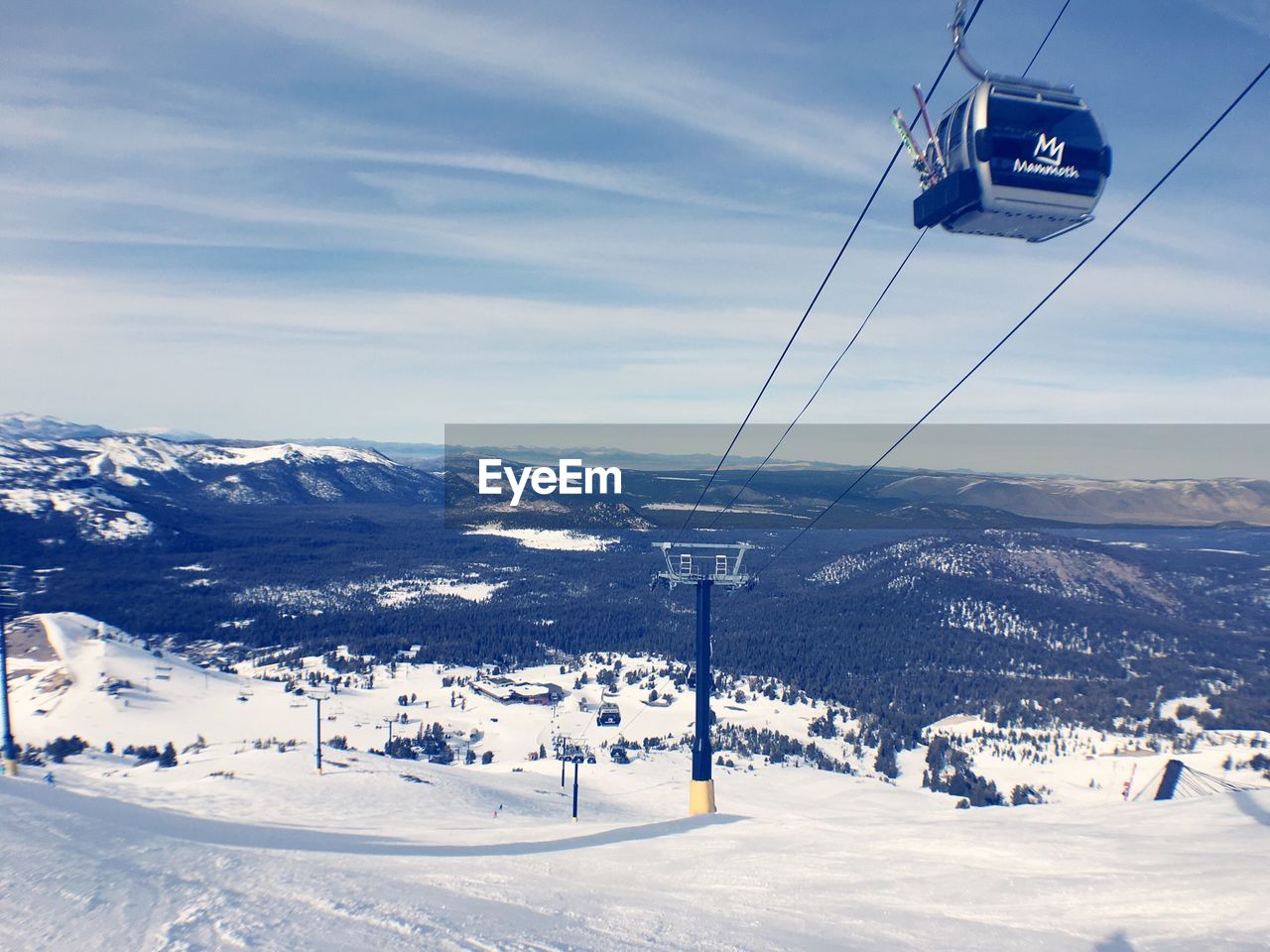 Low angle view of ski lift over snowcapped mountains