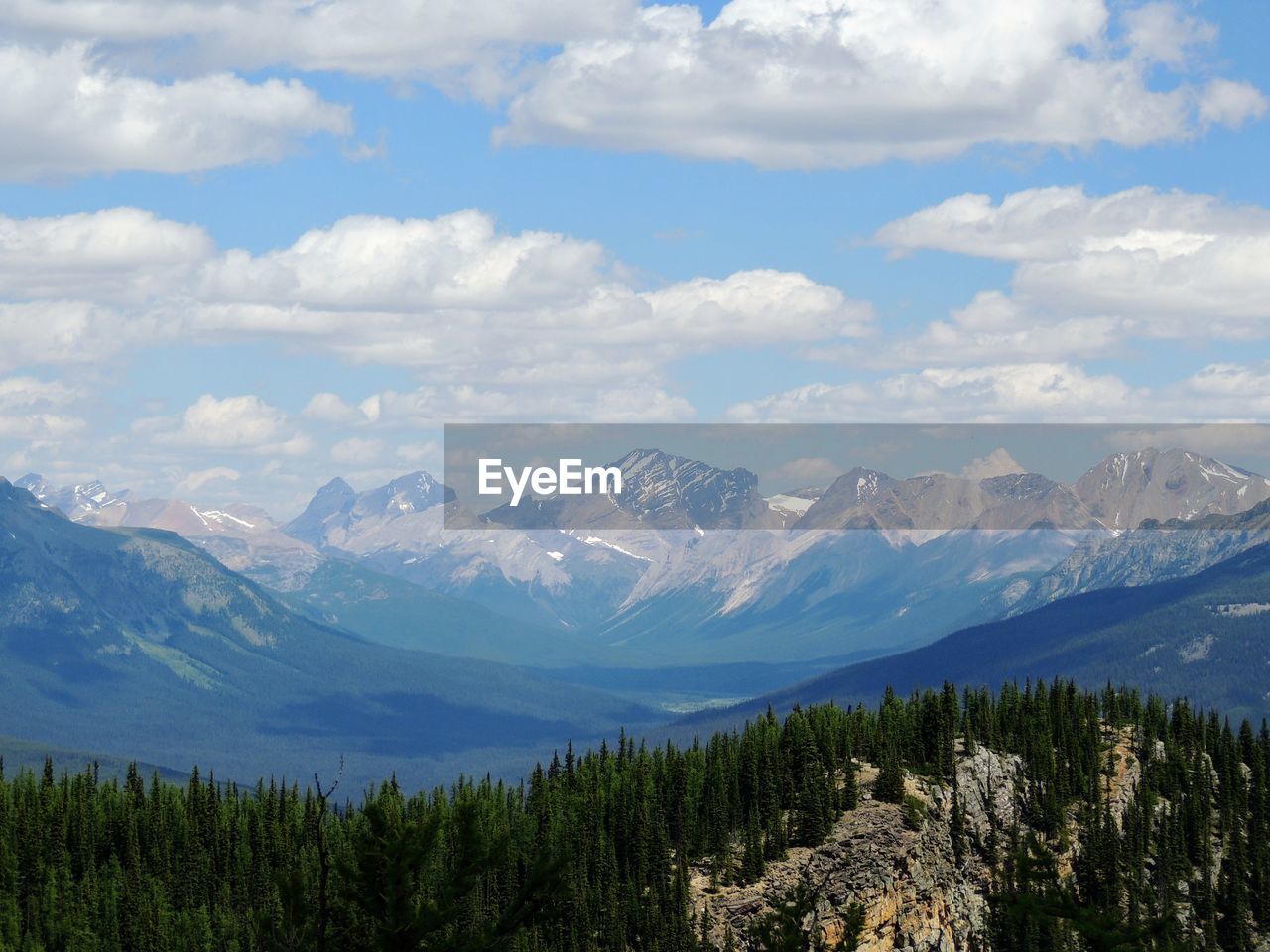 Scenic view of mountains against cloudy sky