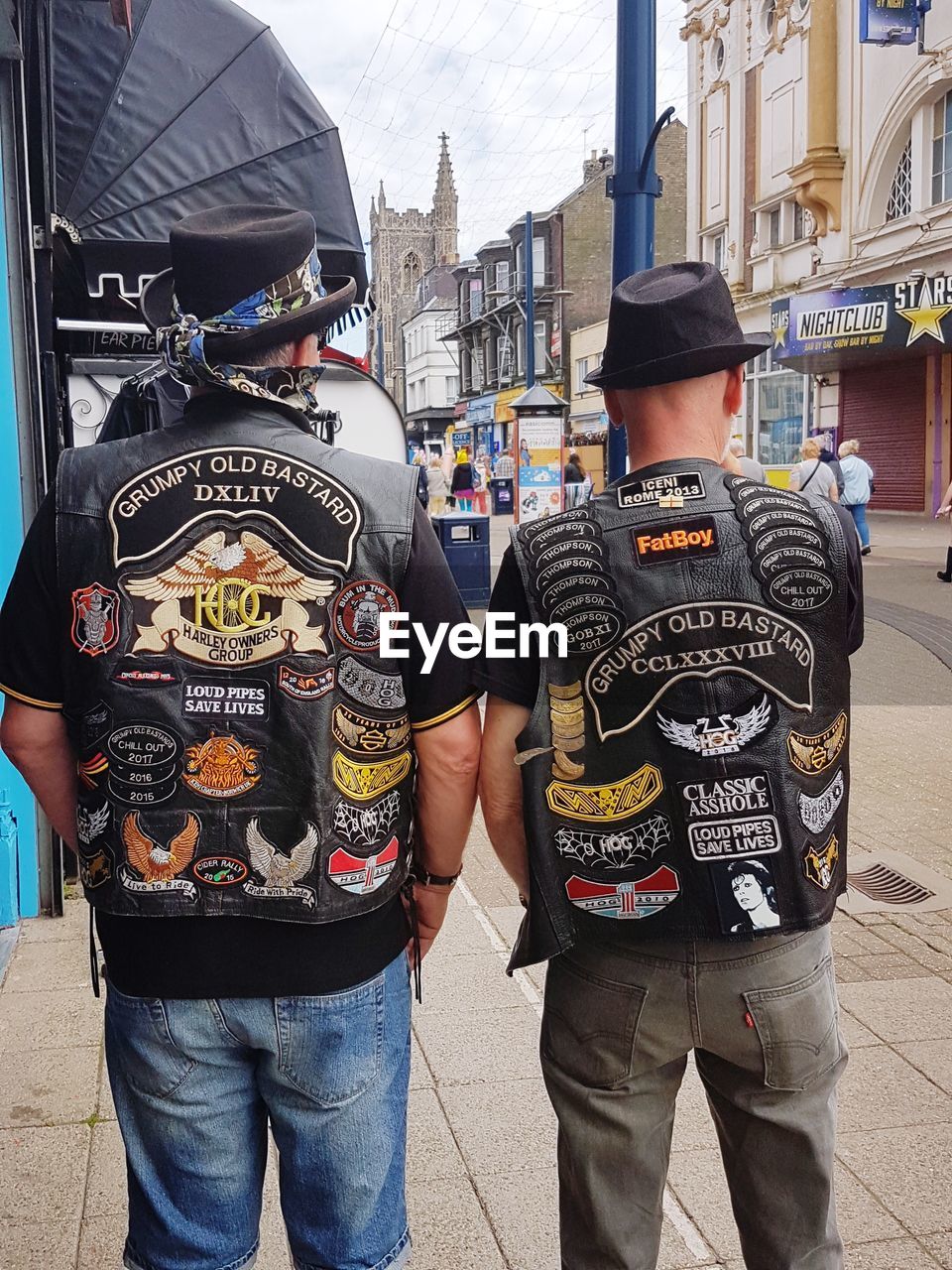 REAR VIEW OF MEN STANDING ON STREET