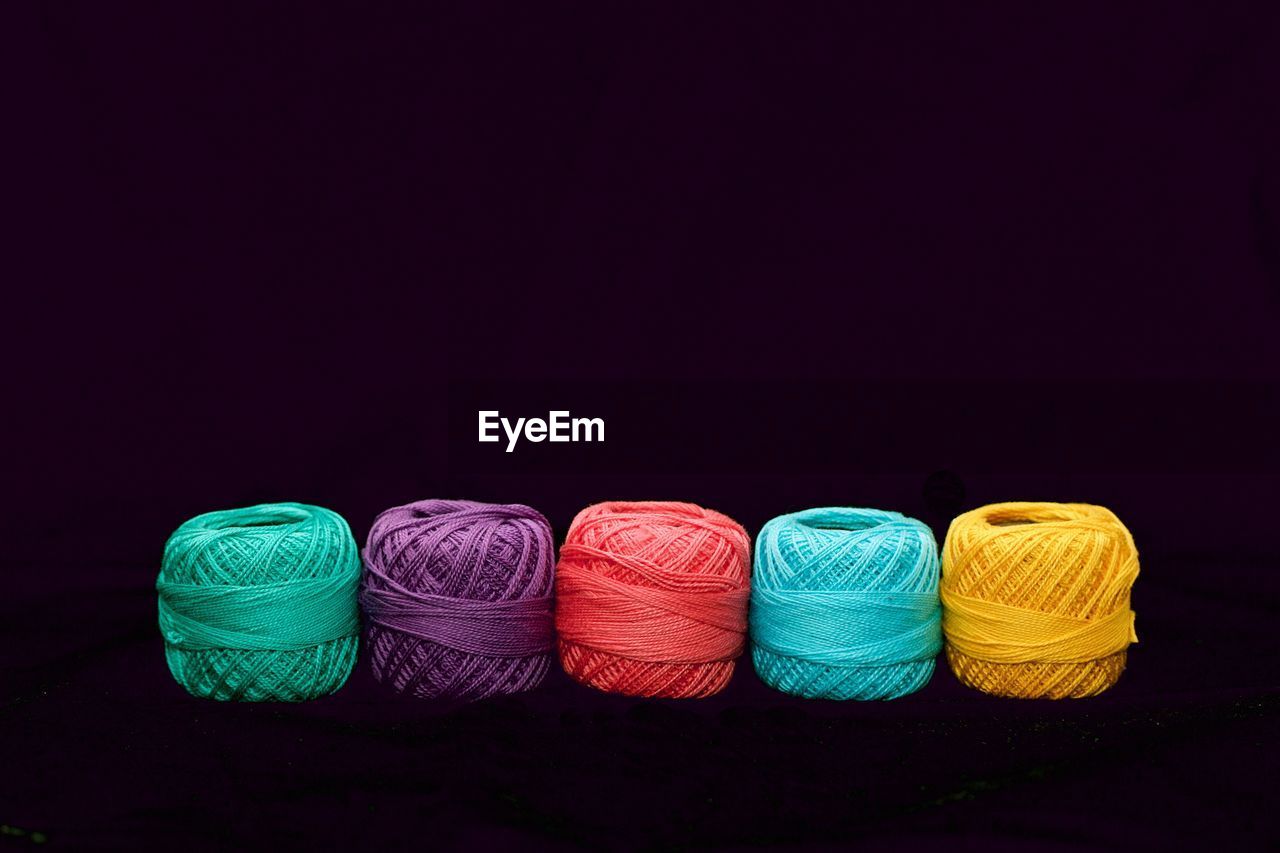 Close-up of colorful wool against black background