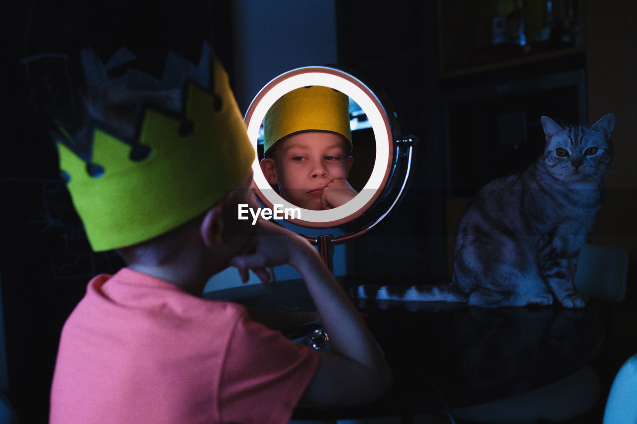 Close-up of boy looking in mirror