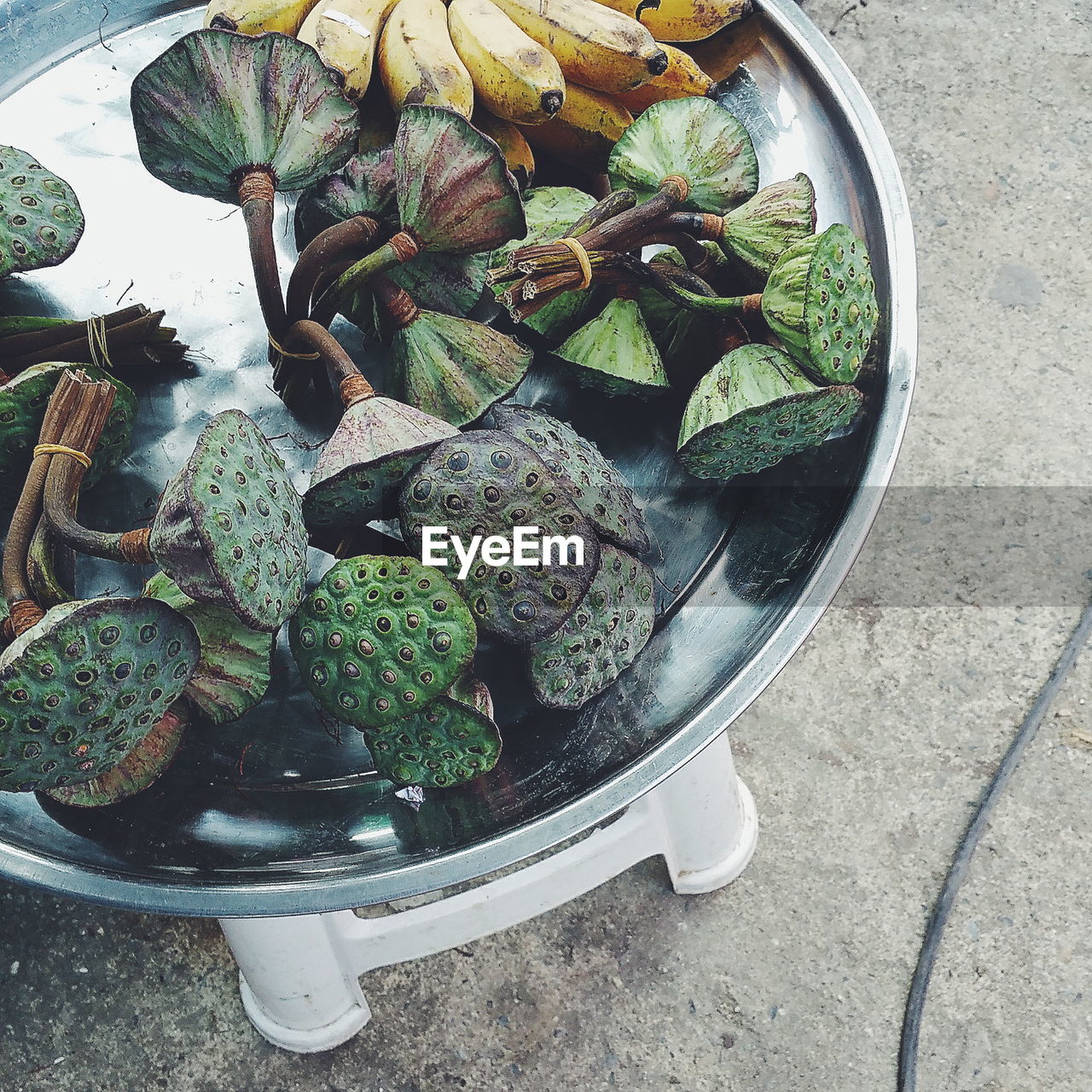 High angle view of lotus pods and bananas in plate