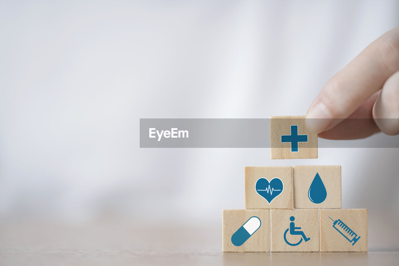 hand, one person, indoors, toy block, toy, copy space, holding, childhood, wood, puzzle, close-up, creativity, adult, studio shot, number, child