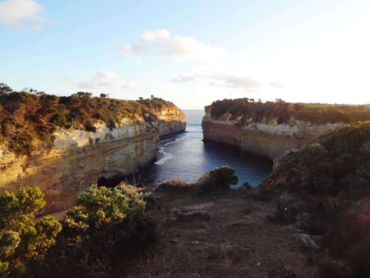 Scenic view of cliff by sea