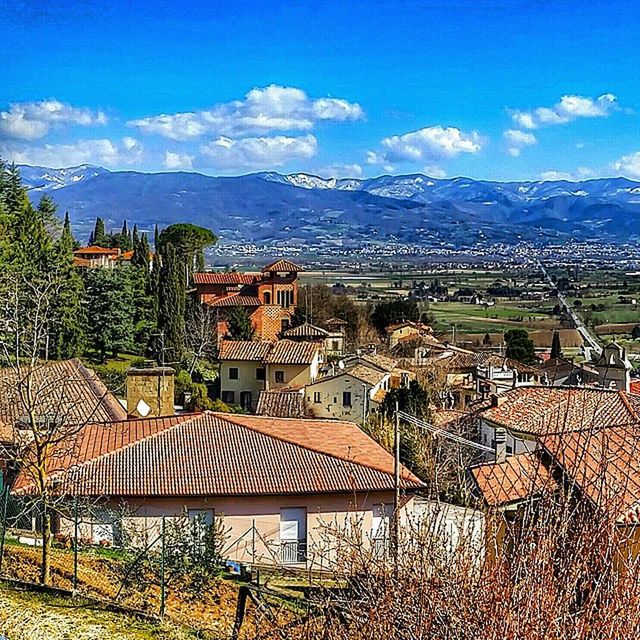 VIEW OF HOUSES AGAINST CLOUDY SKY