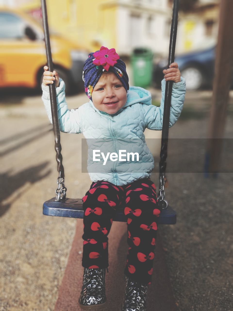 Cute girl holding camera at playground