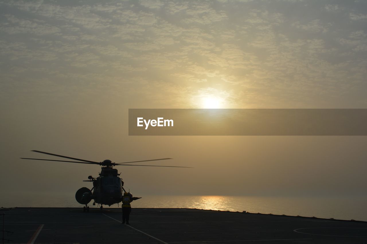 Helicopter against sunset