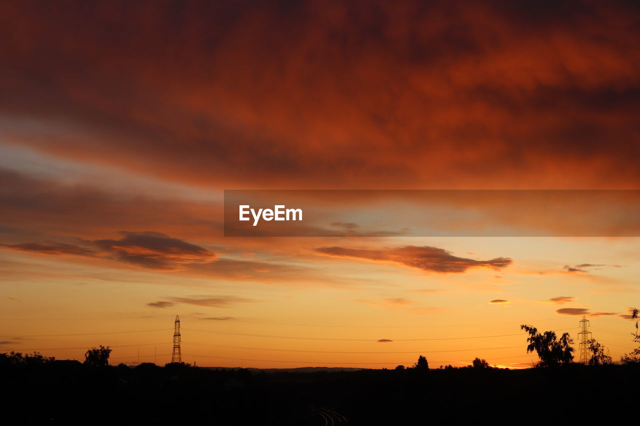 LOW ANGLE VIEW OF SILHOUETTE TREES AGAINST DRAMATIC SKY