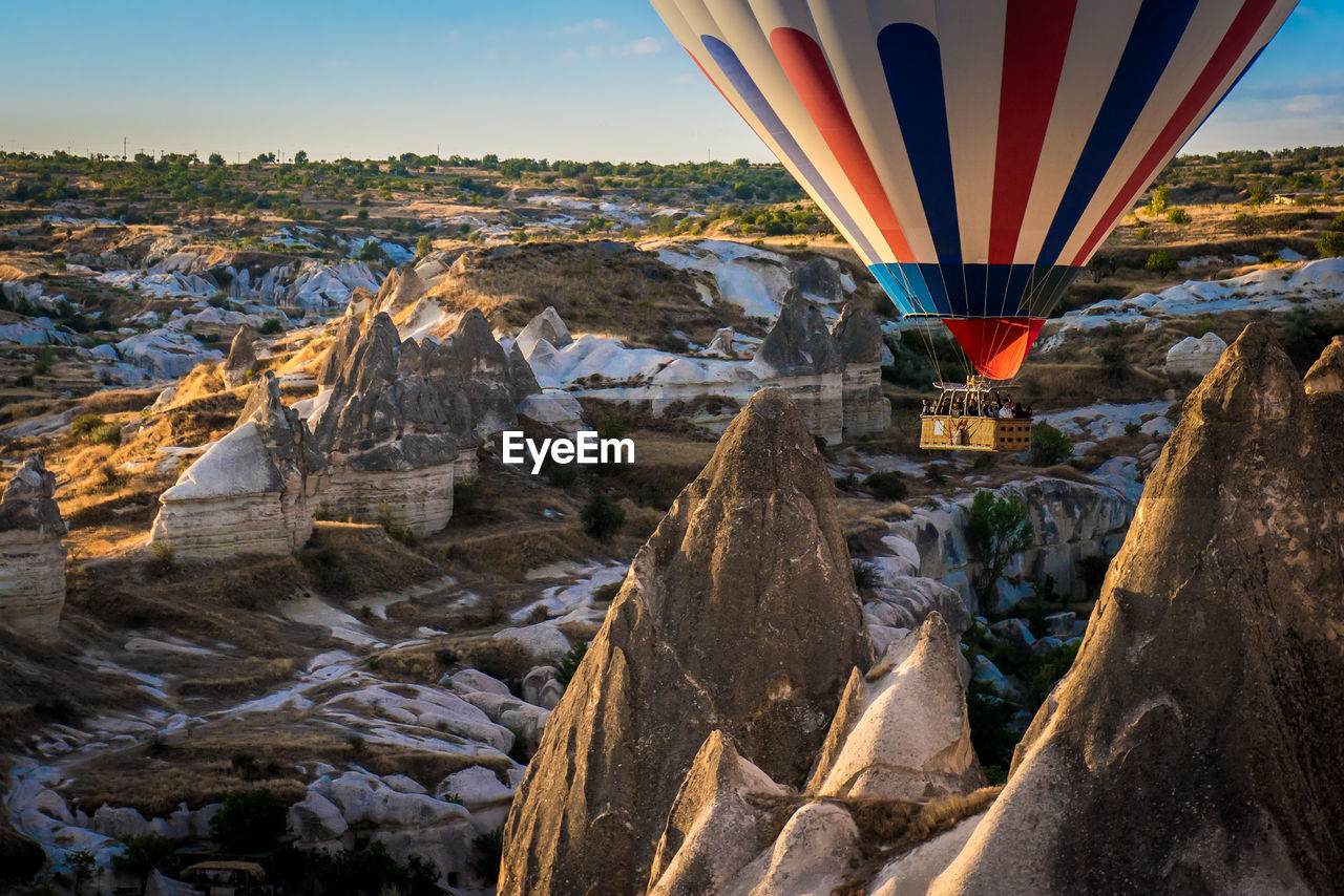 Low angle view of hot air balloon flying over mountains in cappadocia