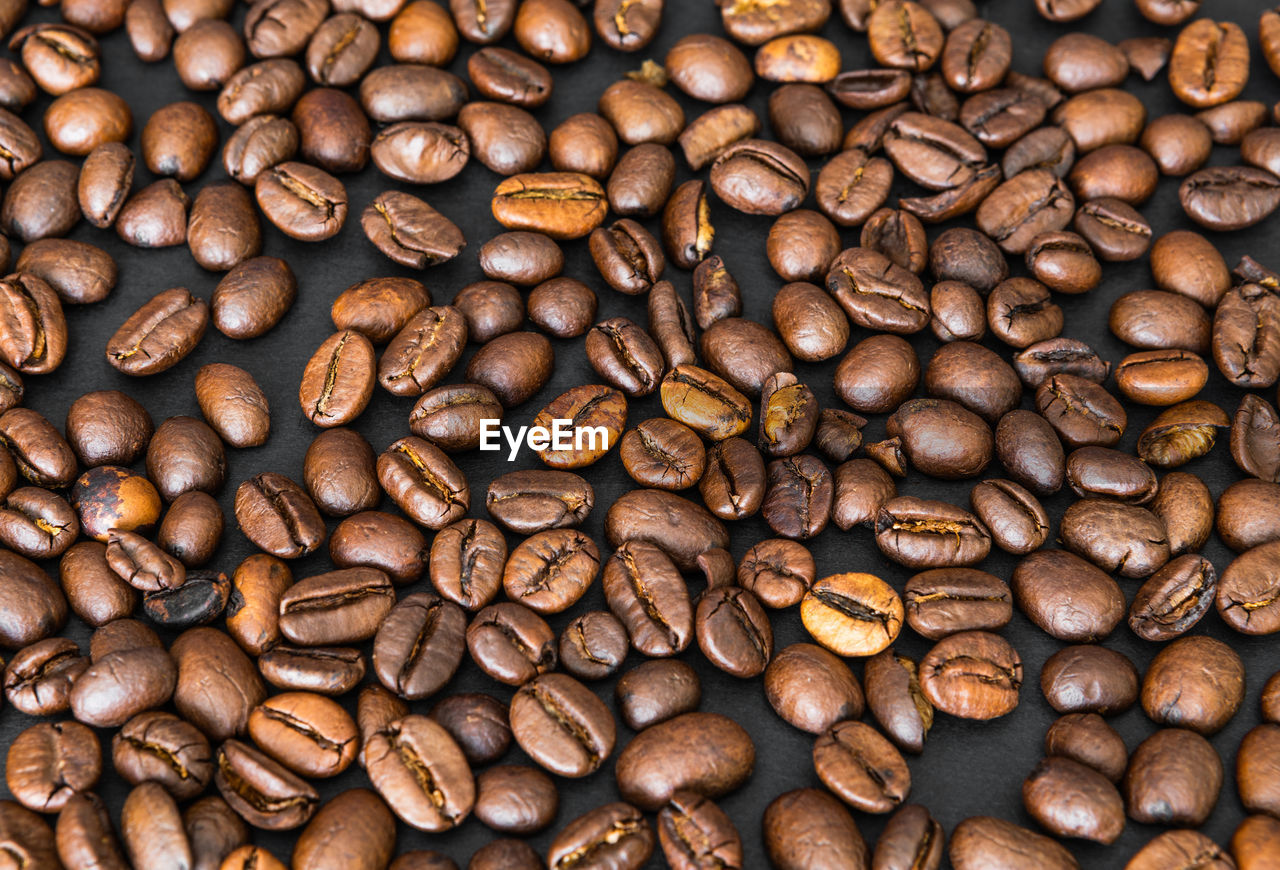 FULL FRAME SHOT OF COFFEE BEANS IN BACKGROUND