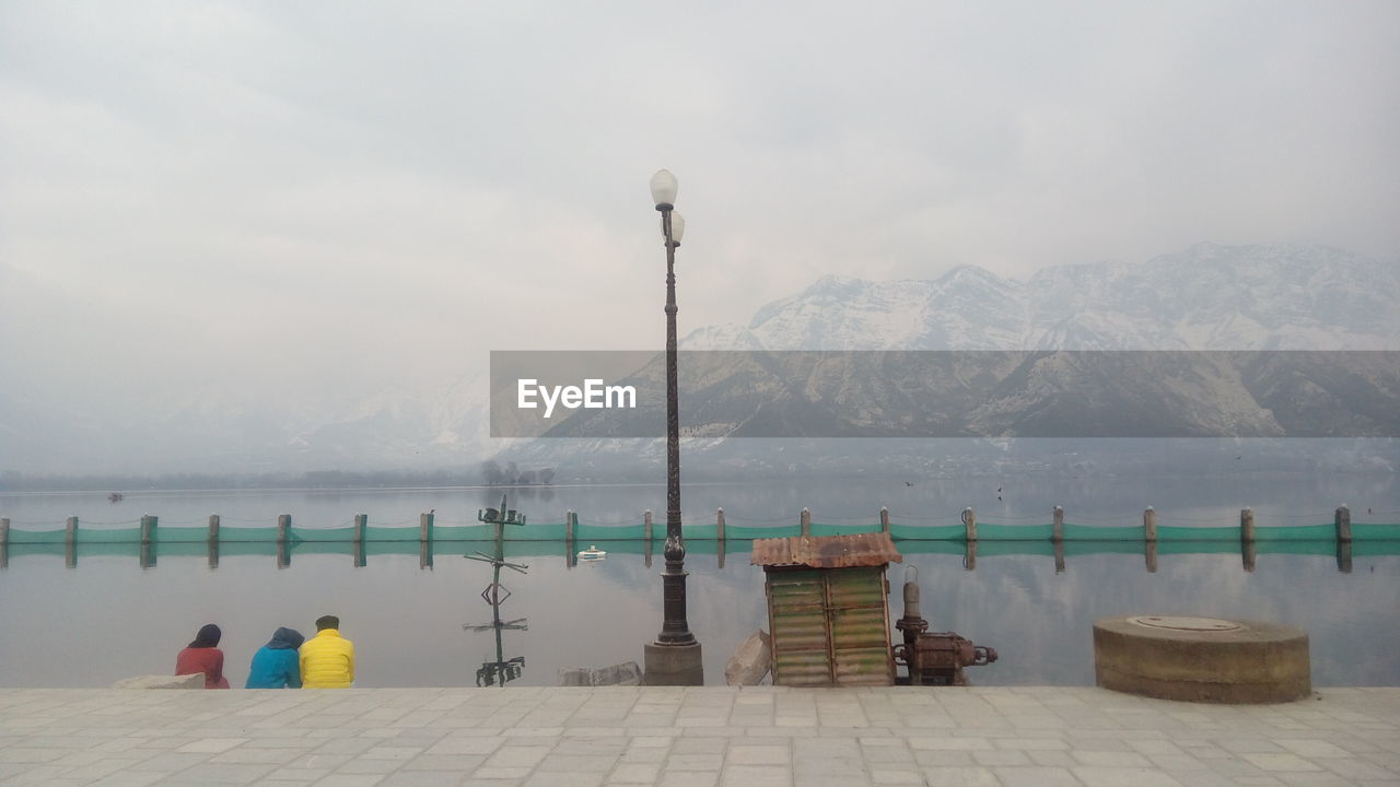 SCENIC VIEW OF LAKE AGAINST MOUNTAIN RANGE