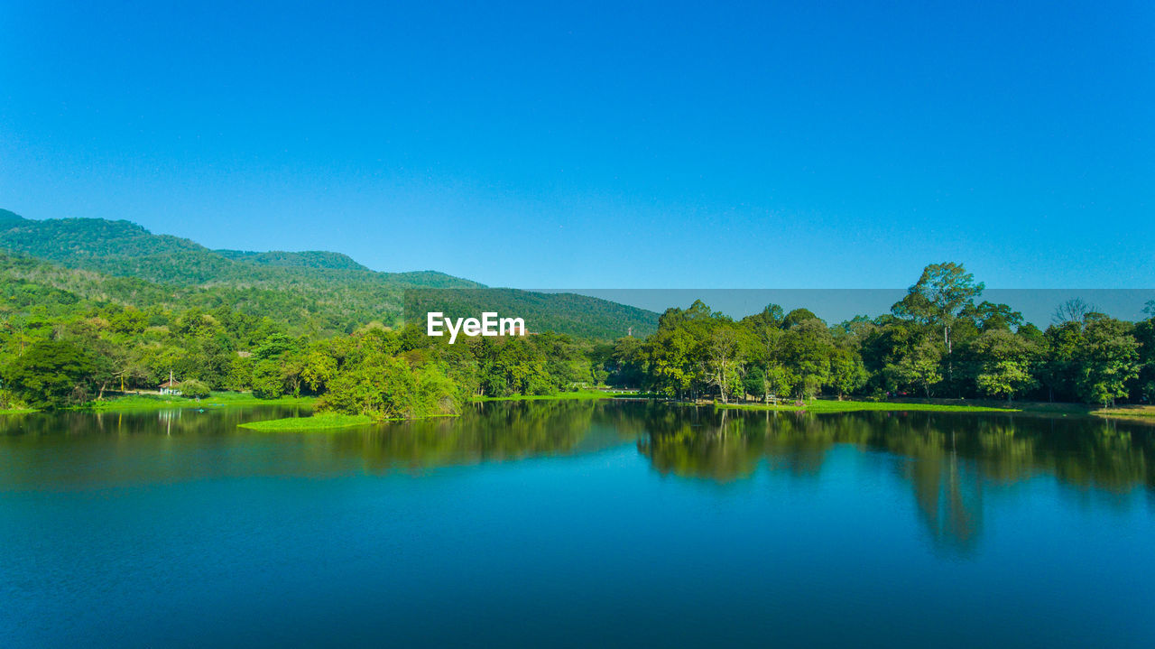 Scenic view of lake against clear blue sky