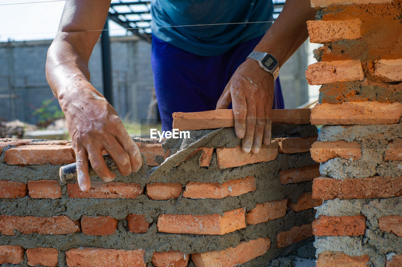 Closeup texture and background of orange bricklayers installed by worker at the construction site