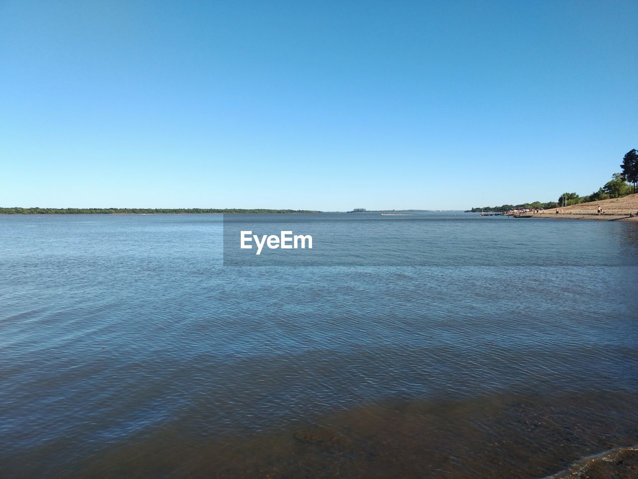 Scenic view of sea against clear blue sky