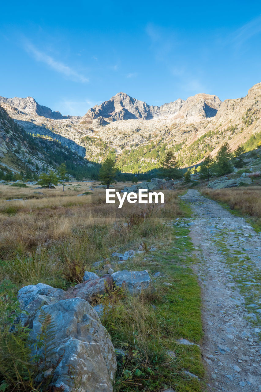 Scenic view of snowcapped mountains against blue sky