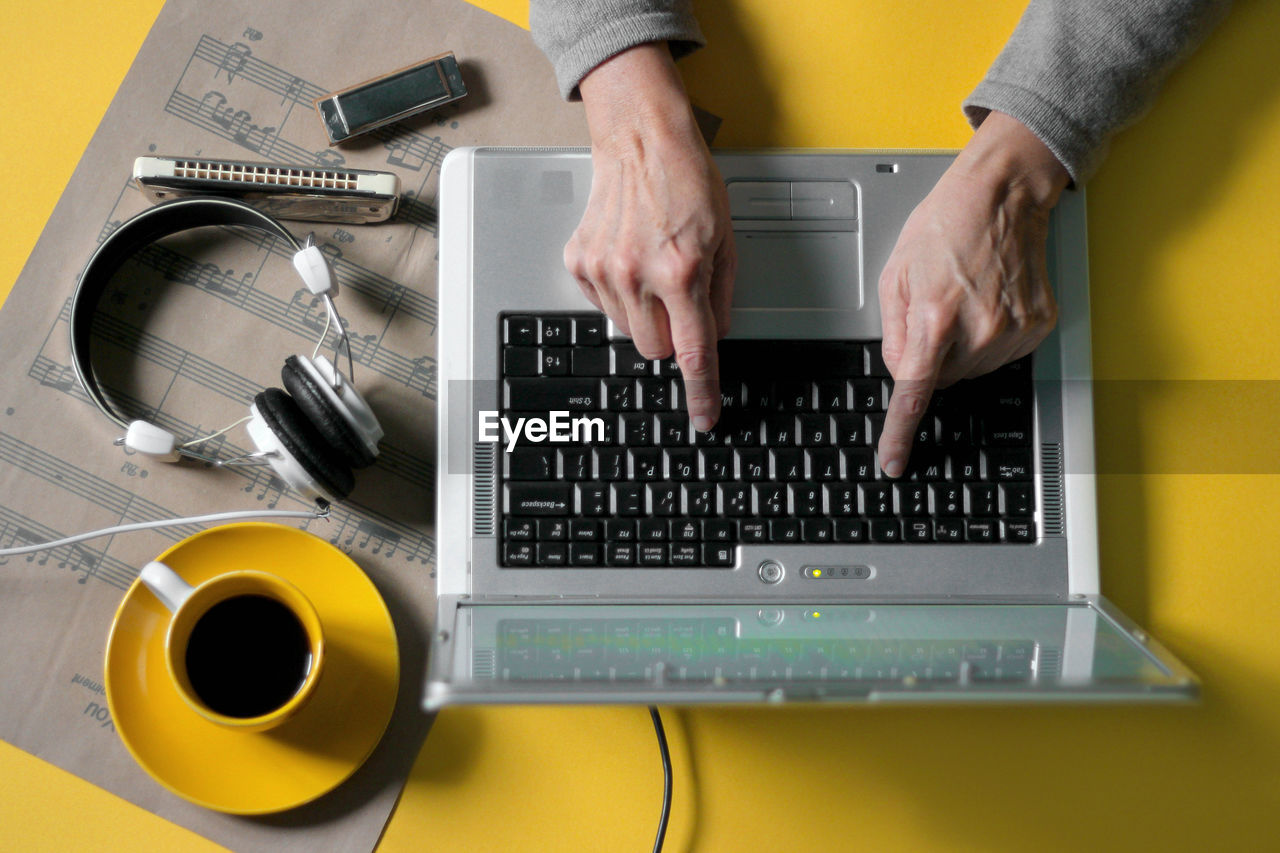 Cropped hands using laptop