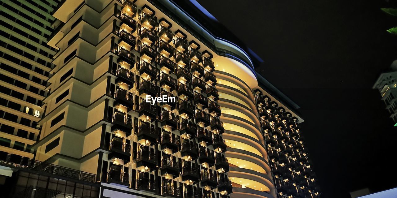 LOW ANGLE VIEW OF ILLUMINATED BUILDINGS AGAINST SKY