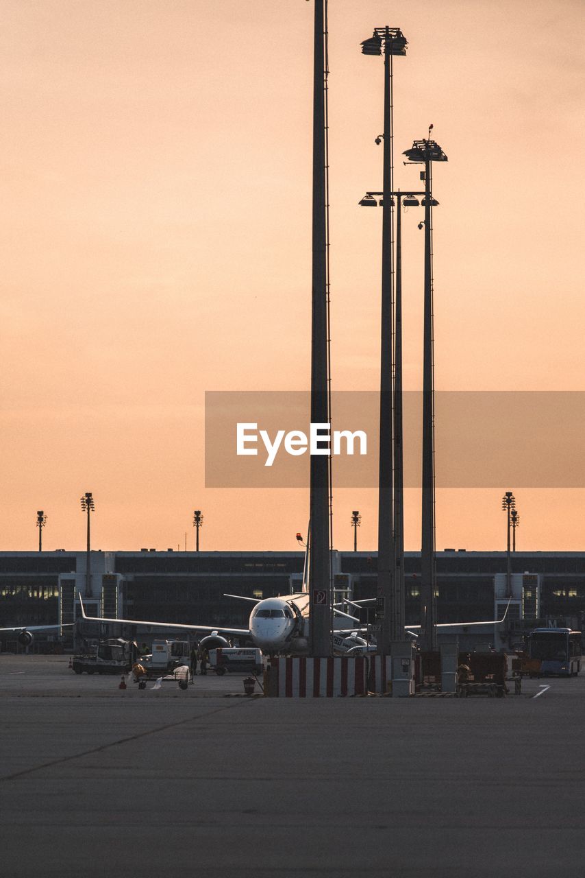 AIRPORT RUNWAY AGAINST SKY DURING SUNSET