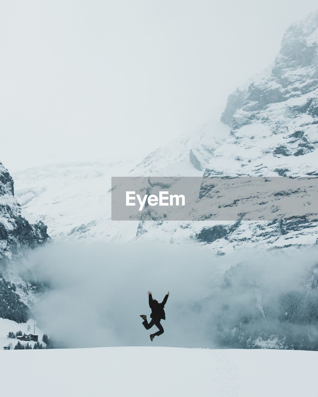 MAN JUMPING IN SNOW