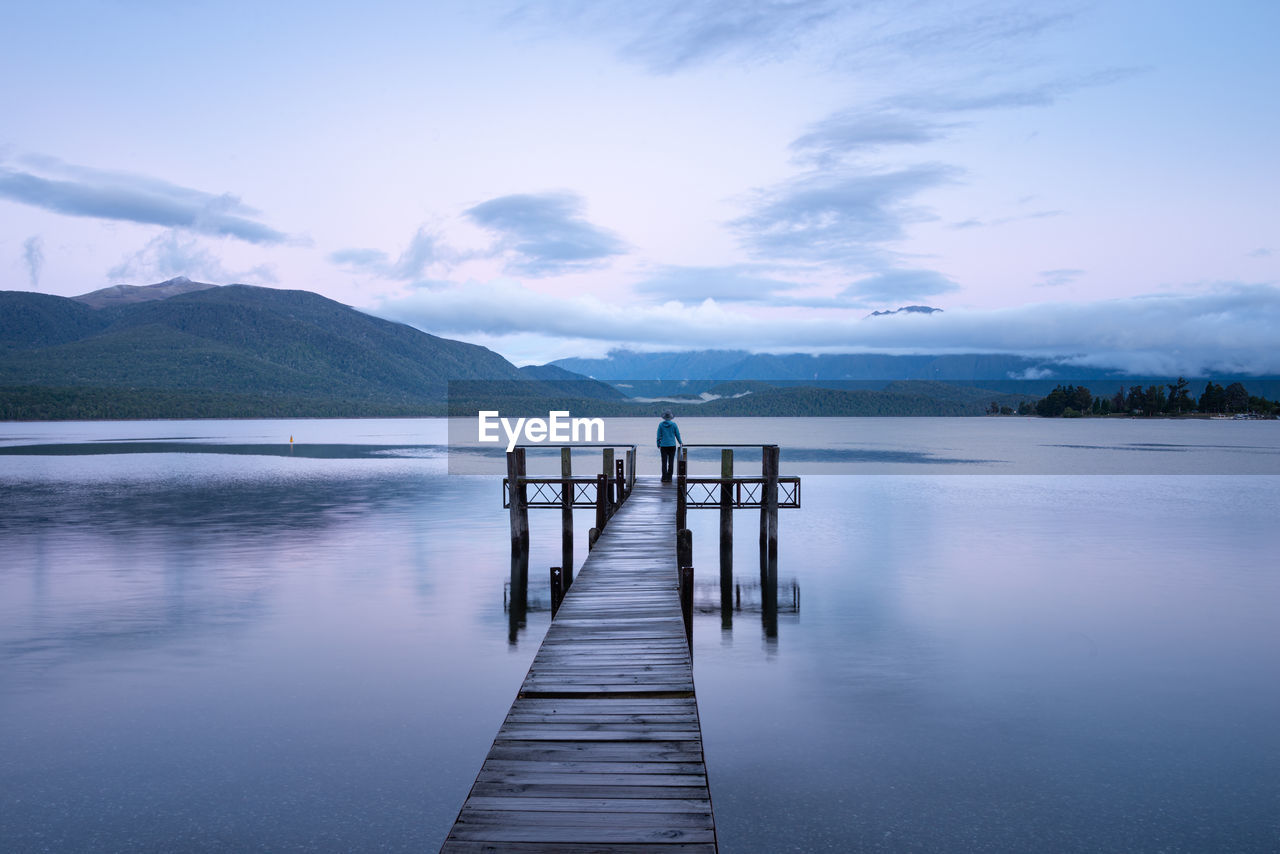 Pier over lake against sky