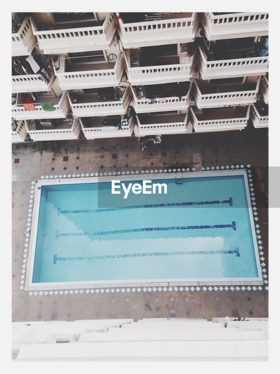 High angle view of swimming pool by building with balconies