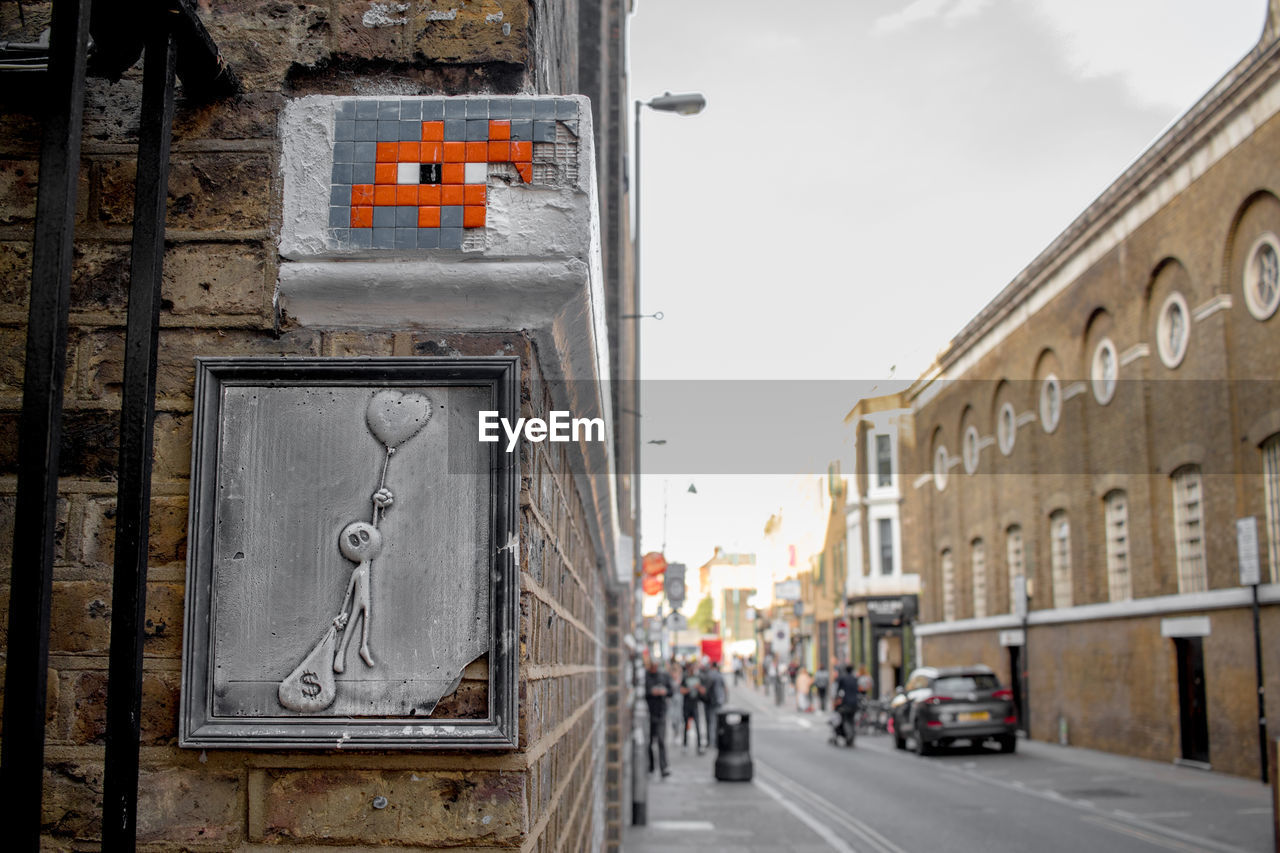 STREET BY BUILDING AGAINST SKY