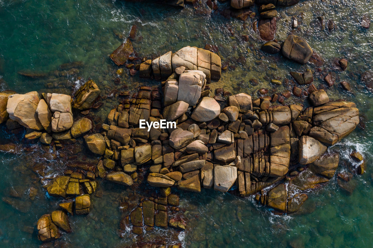 Aerial view of rocks in sea