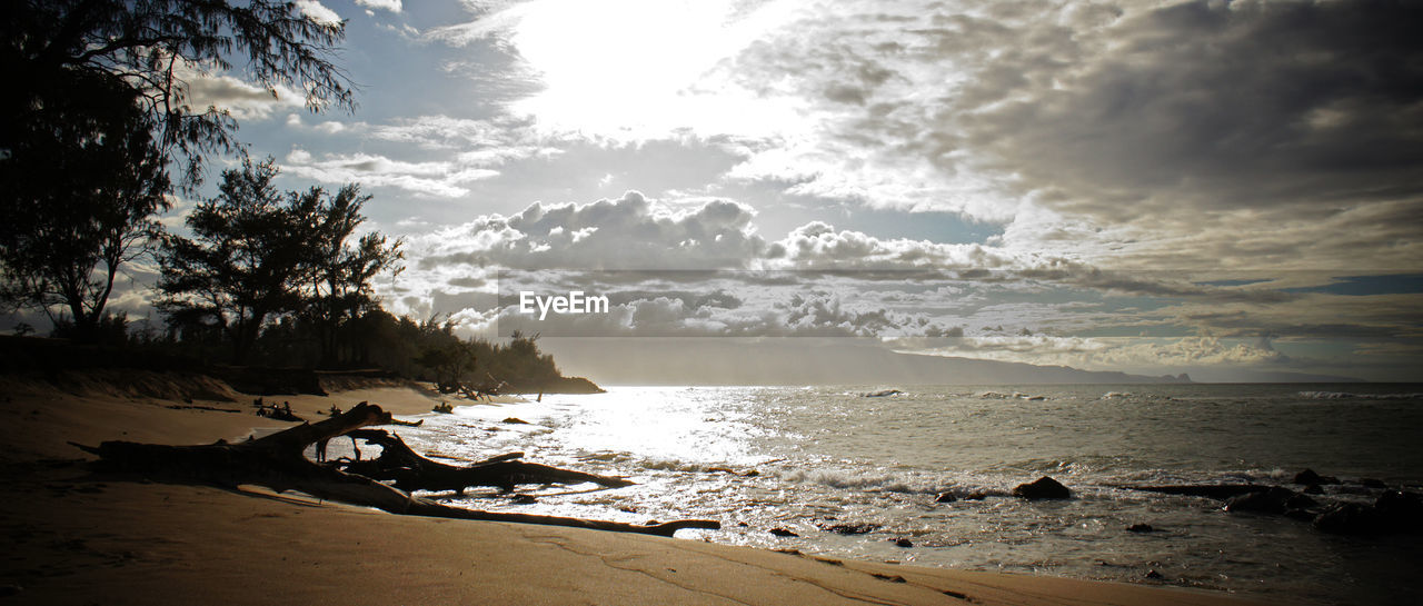 Scenic view of beach against sky during sunset