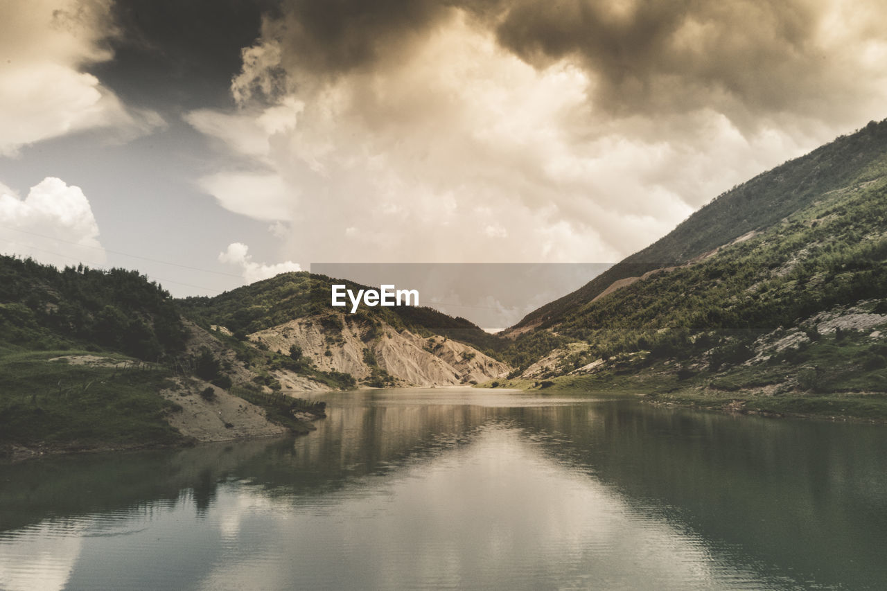 Scenic view of lake and mountains against sky