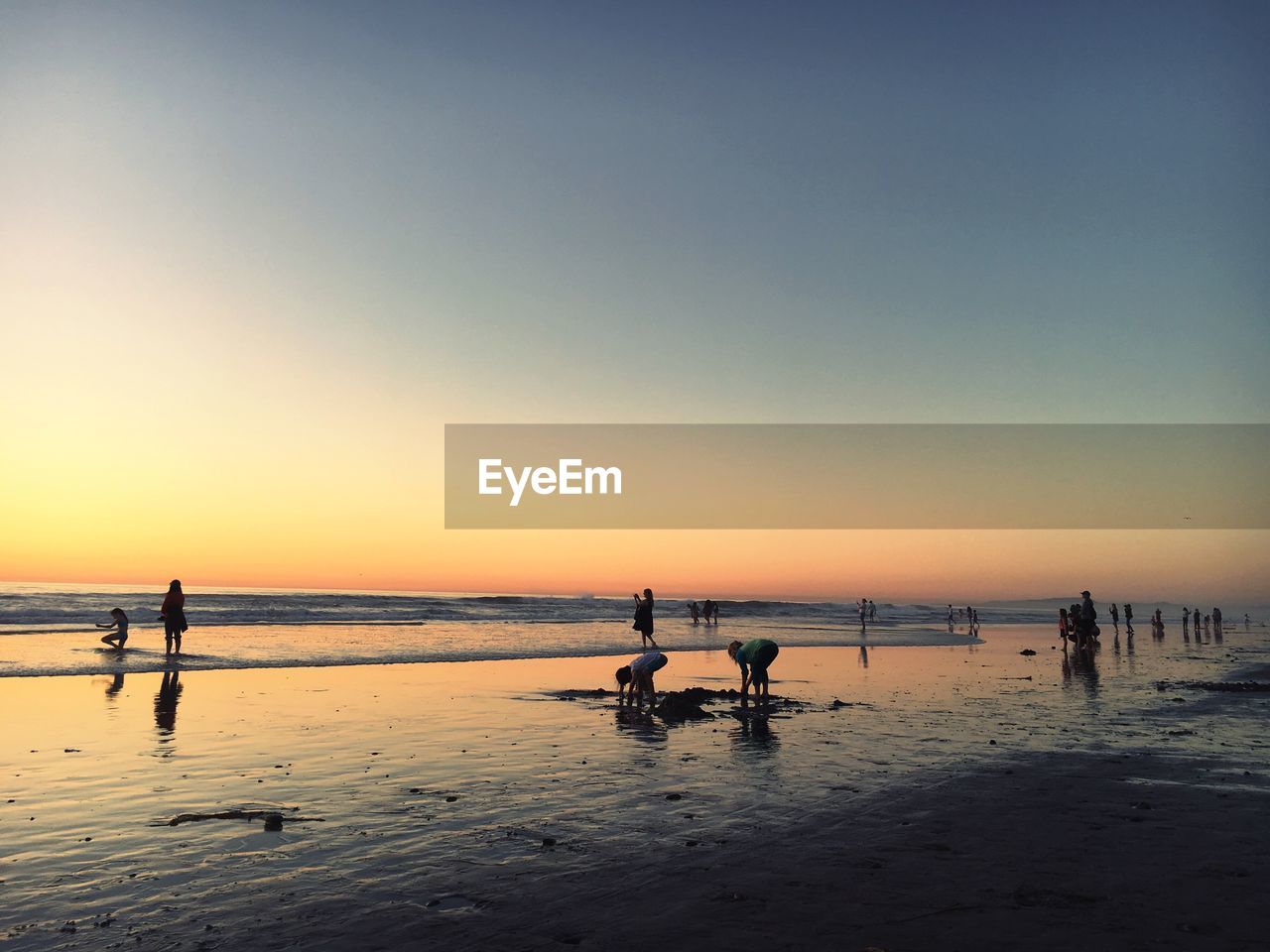 SILHOUETTE BEACH AGAINST CLEAR SKY DURING SUNSET