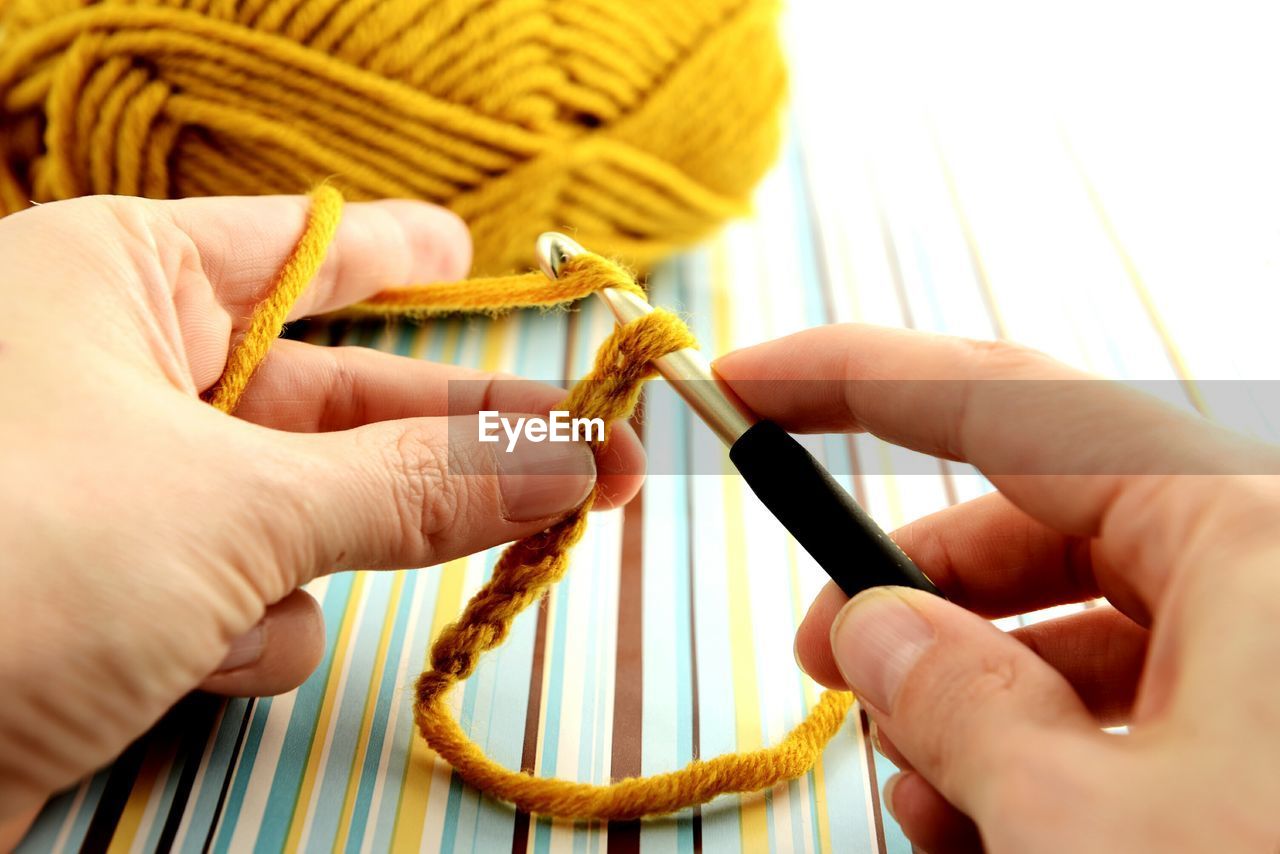 Cropped image of woman crocheting wool