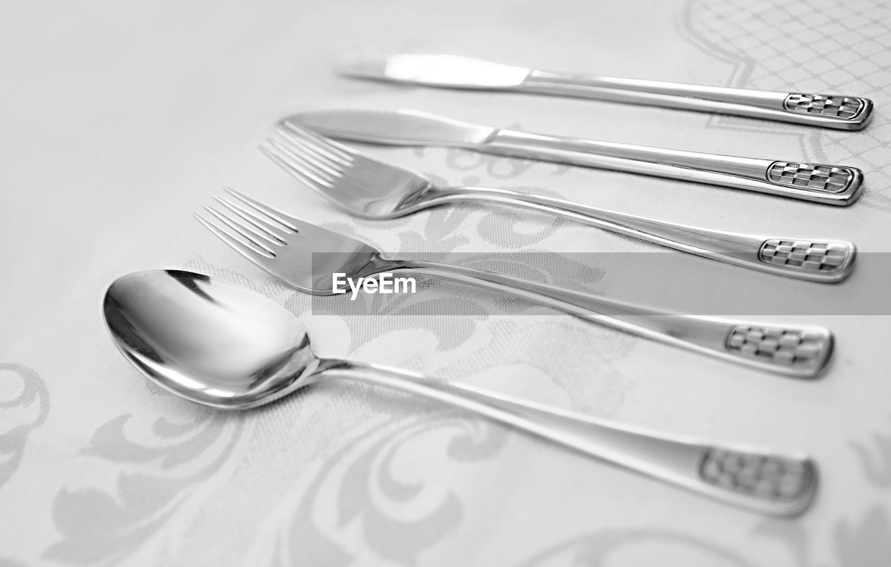 Silverware utensils with knife fork and spoons on a table no people stock photo
