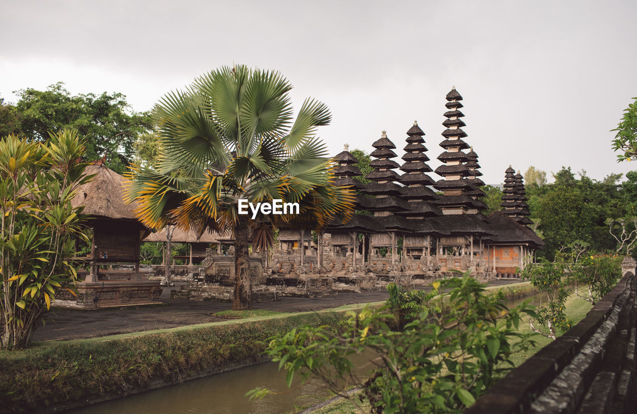 Exterior of temple by building against sky