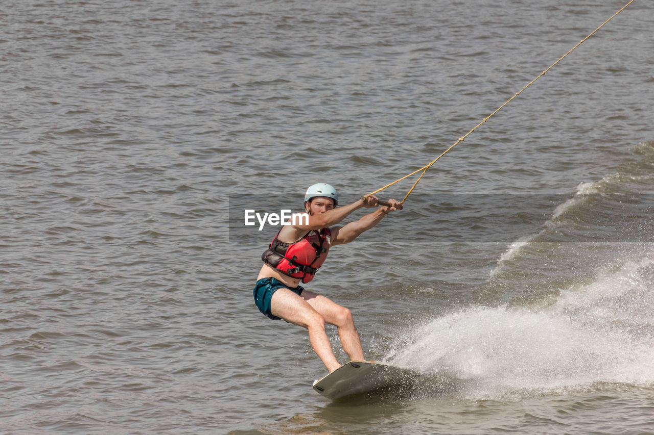 Man kite boarding in river