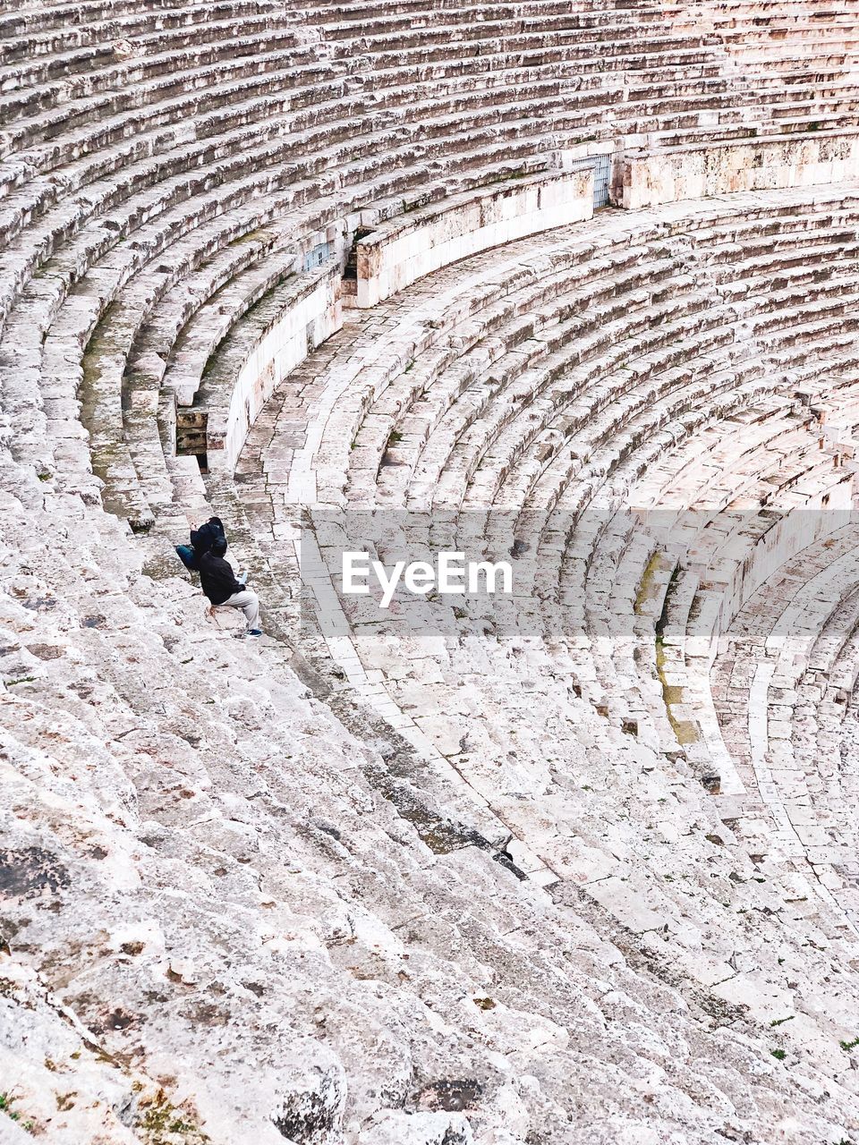 HIGH ANGLE VIEW OF HUMAN FEET OF OLD RUIN