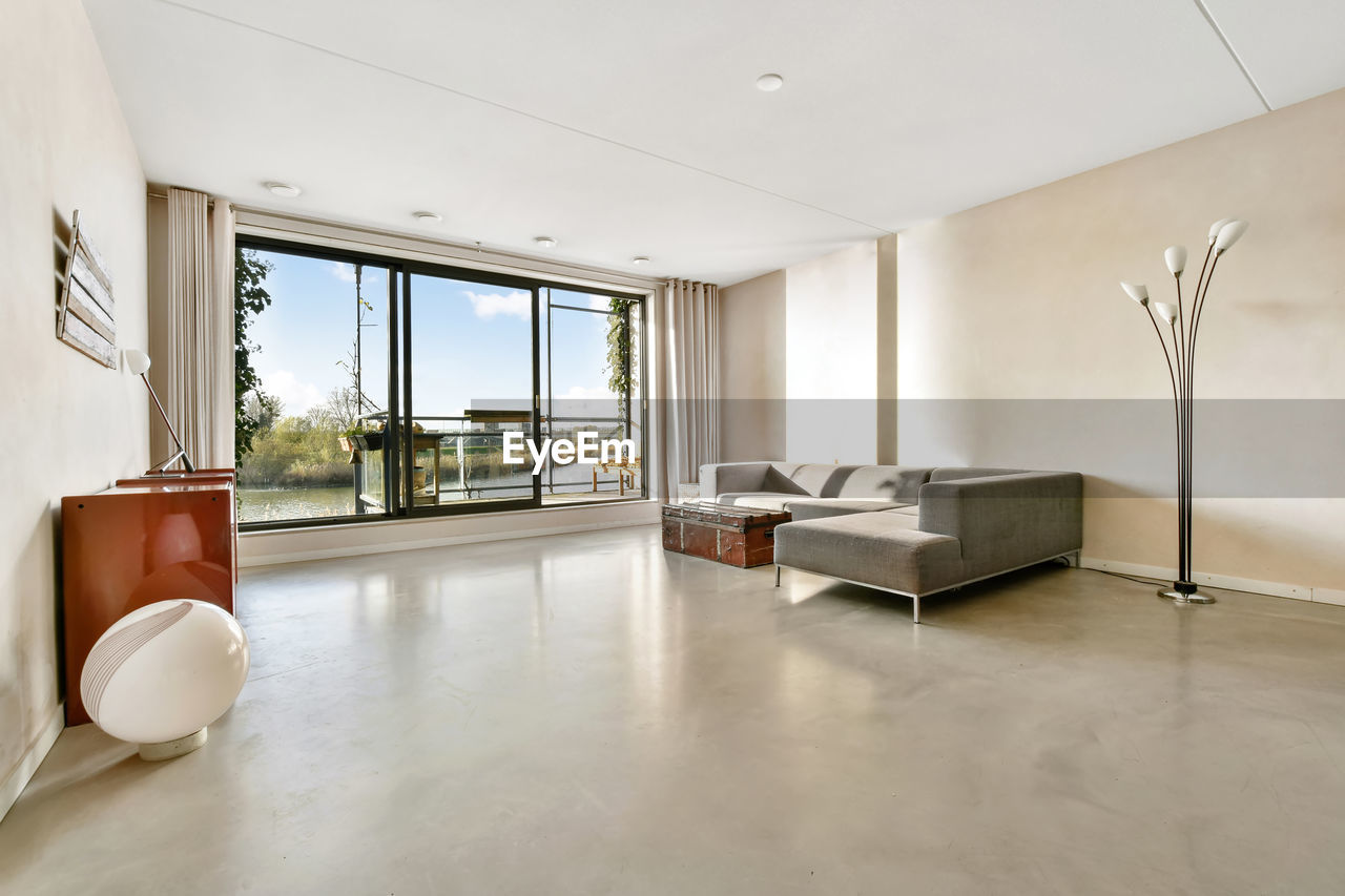 INTERIOR OF HOME AND TABLE AGAINST WHITE WALL AT WINDOW