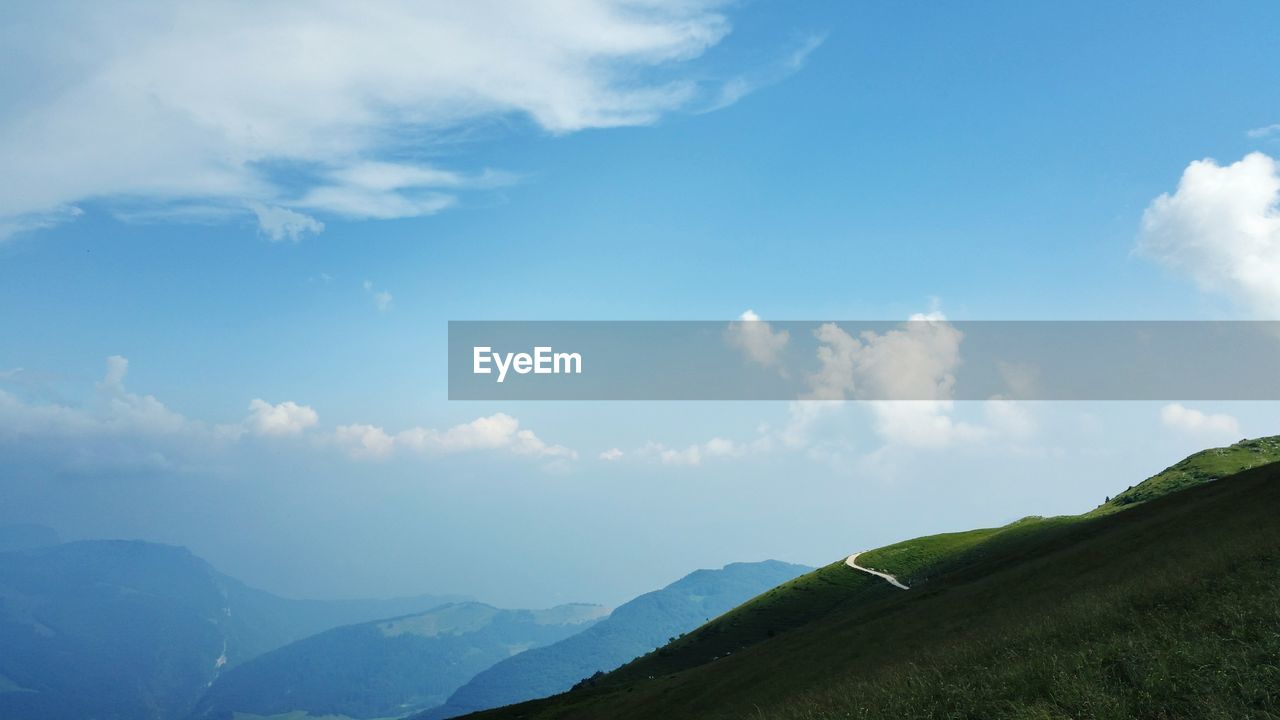 Scenic view of mountains against cloudy sky