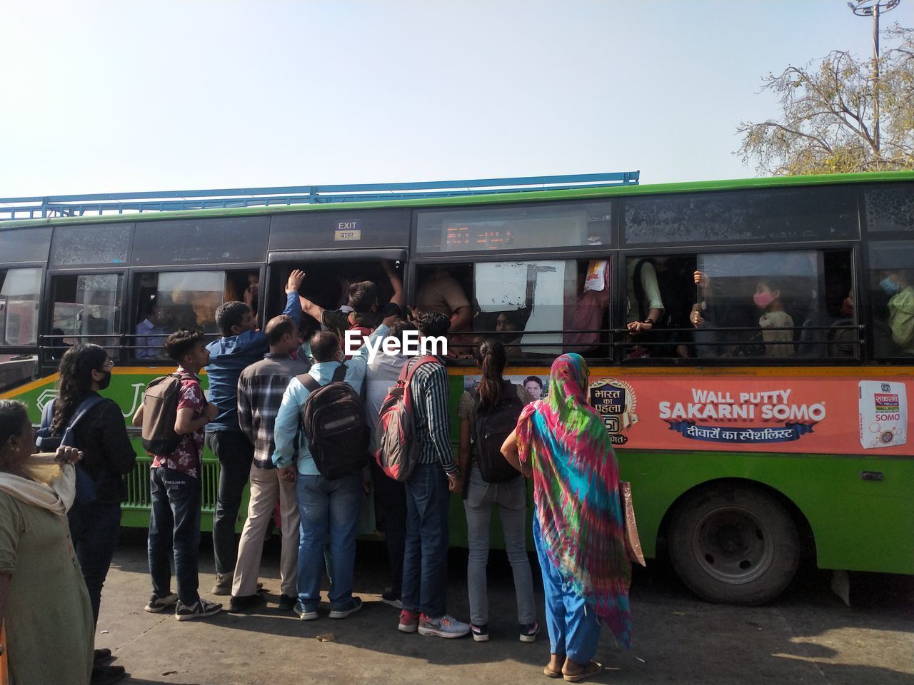 bus, transport, group of people, vehicle, transportation, mode of transportation, crowd, land vehicle, men, adult, city, large group of people, architecture, public transport, women, public transportation, tour bus service, person, day, travel, standing, outdoors
