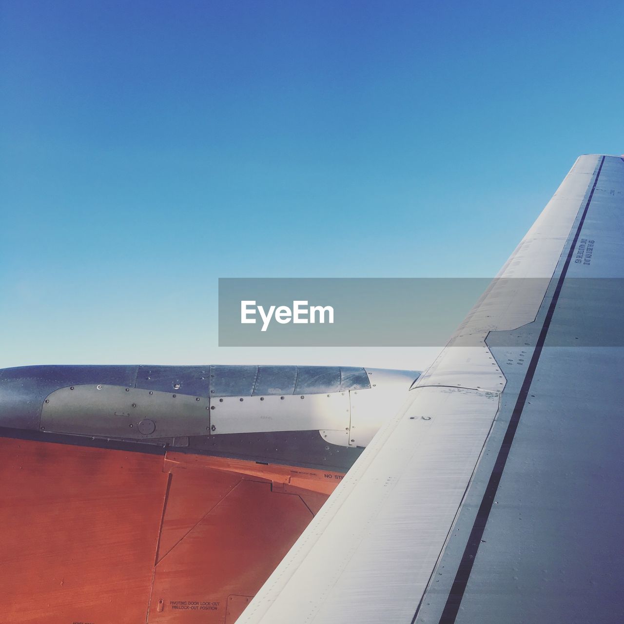 Airplane wing against blue sky