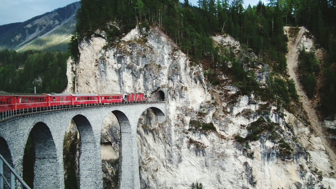 BRIDGE OVER MOUNTAIN AGAINST SKY