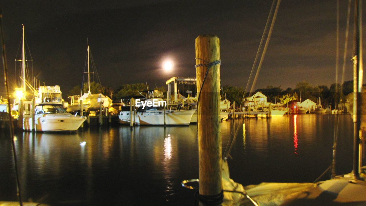 BOATS MOORED AT HARBOR