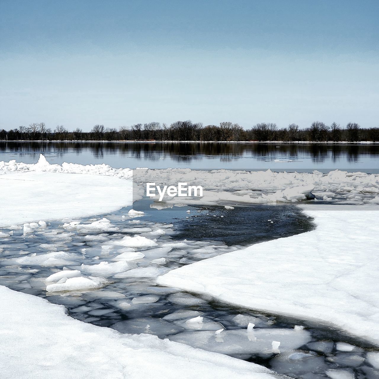 FROZEN LAKE AGAINST SKY