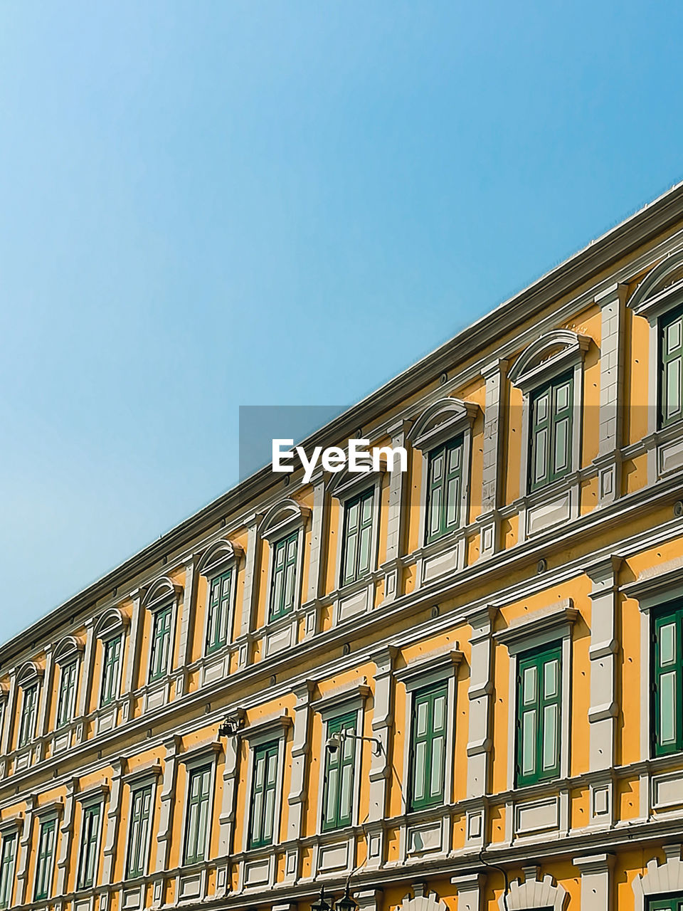 Low angle view of building against clear blue sky