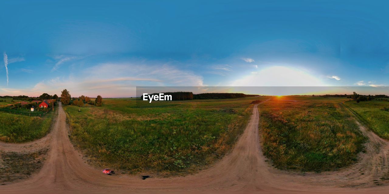 PANORAMIC SHOT OF ROAD AMIDST FIELD AGAINST SKY