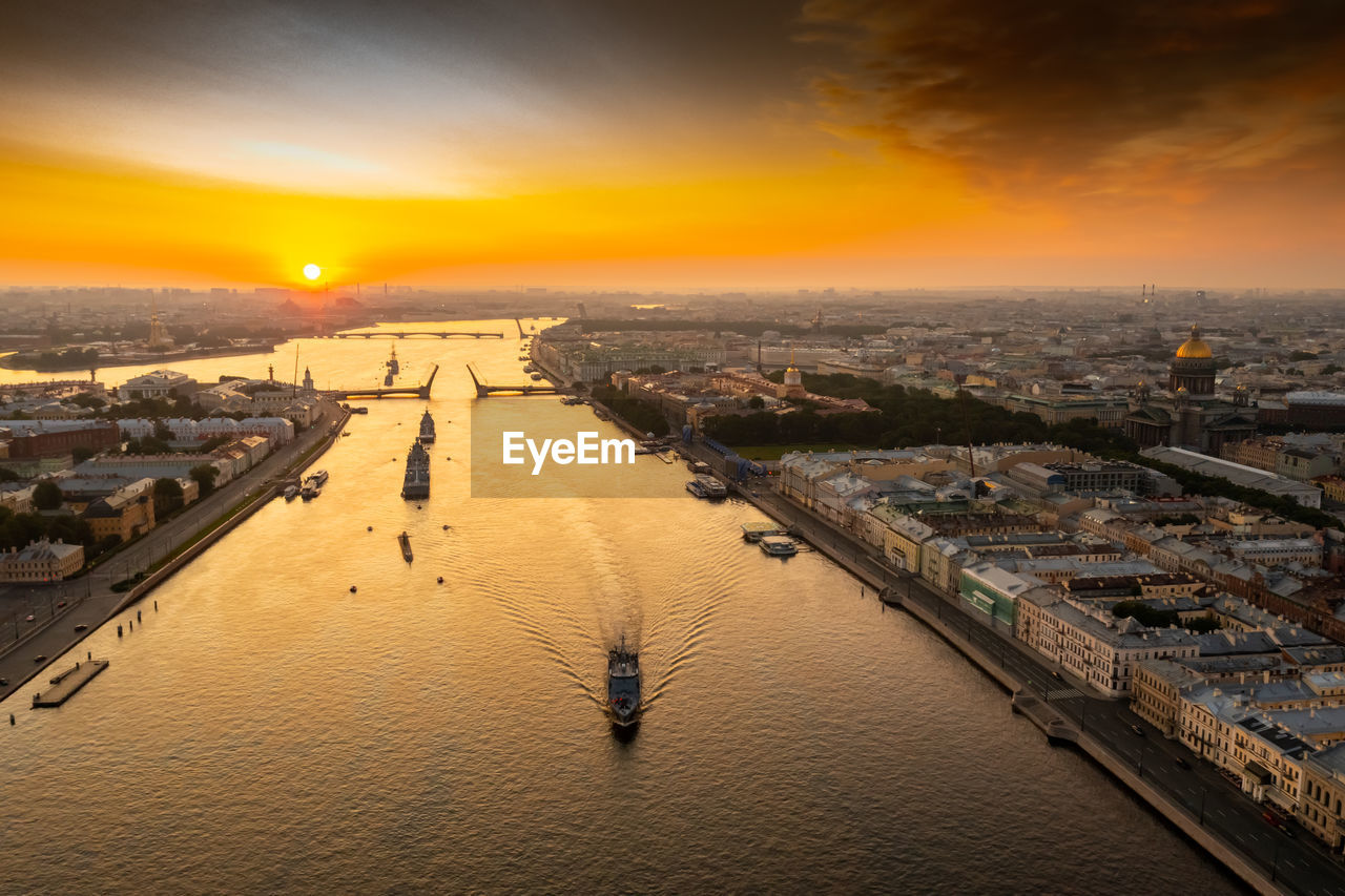 high angle view of illuminated cityscape against sky during sunset